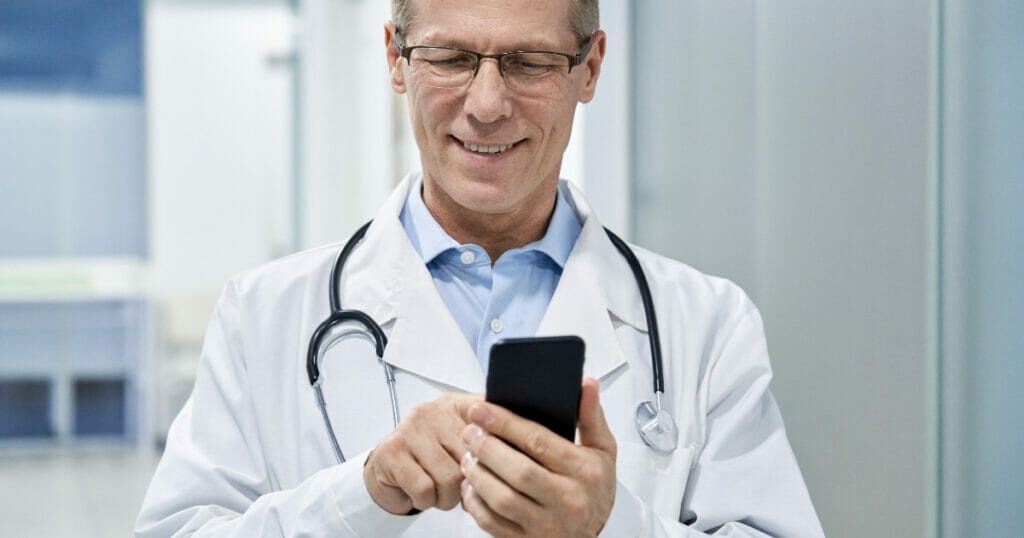 doctor smiling on their phone