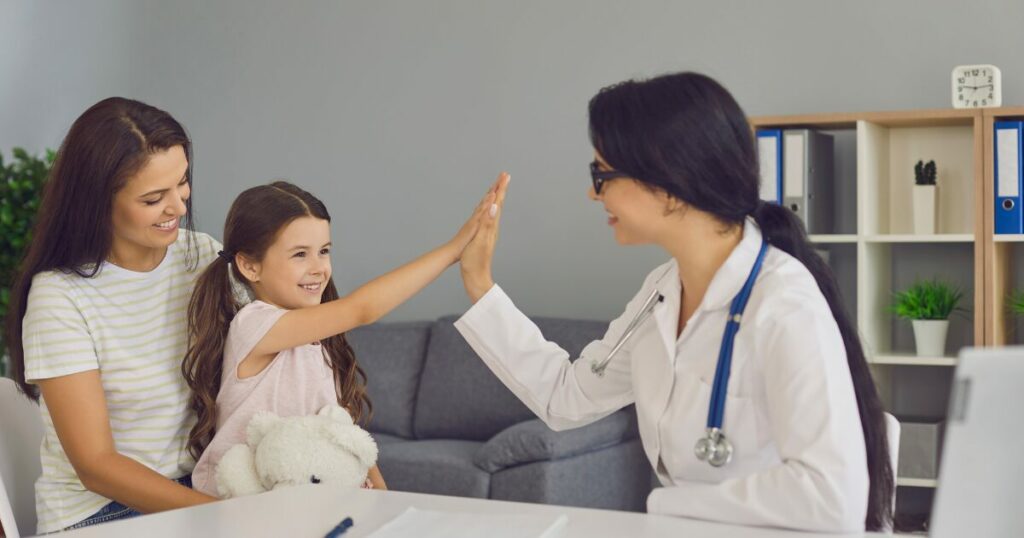 parent with child high fiving a doctor
