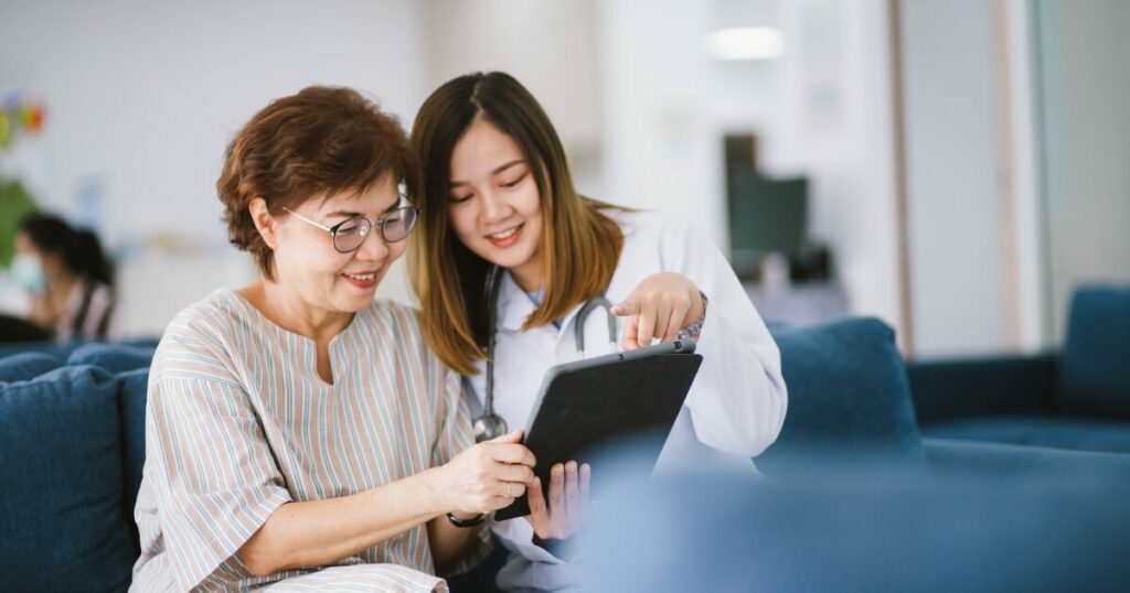 nurse and woman on a tablet